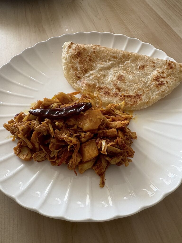 kacha kathal/echor curry/green jackfruit served with a paratha