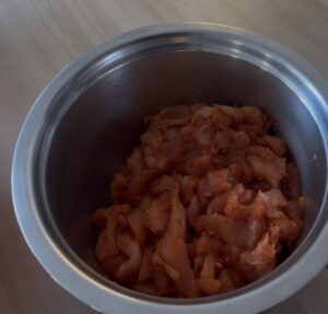 butter chicken marinated in a bowl