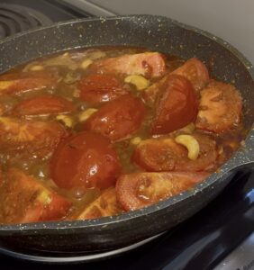 tomatoes and cashews being sautéed for the butter chicken gravy