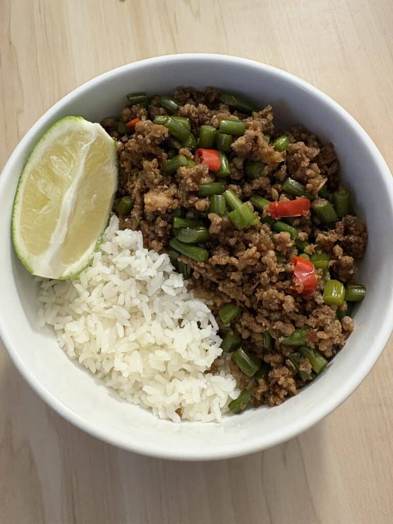 garlic scapes stir fry with minced beed served with white rice.